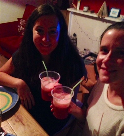 A photo of Sarah and Abi drinking a strawberry and beetroot cocktail