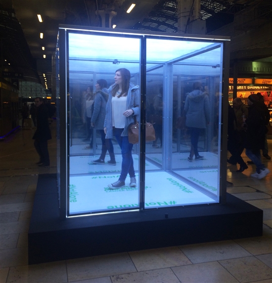 Photograph of a woman in the isolation box at Paddington station