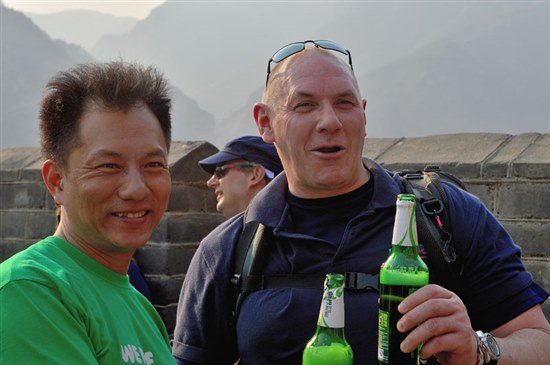 Photograph of two guides drinking beer at the top of the Wall