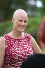 Photograph showing a lady with hair loss, standing outside