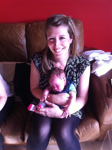 Photo showing Macmillan employee and her baby at a coffee morning