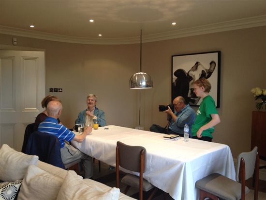 Photograph showing a Macmillan photoshoot in action. There is a cameraman and people having their picture taken