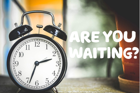 A black and white clock with the words 'are you waiting?' written in white. 