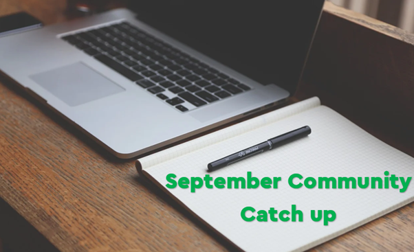 Laptop with a pen and paper next to it. September Community catch up written in green. 