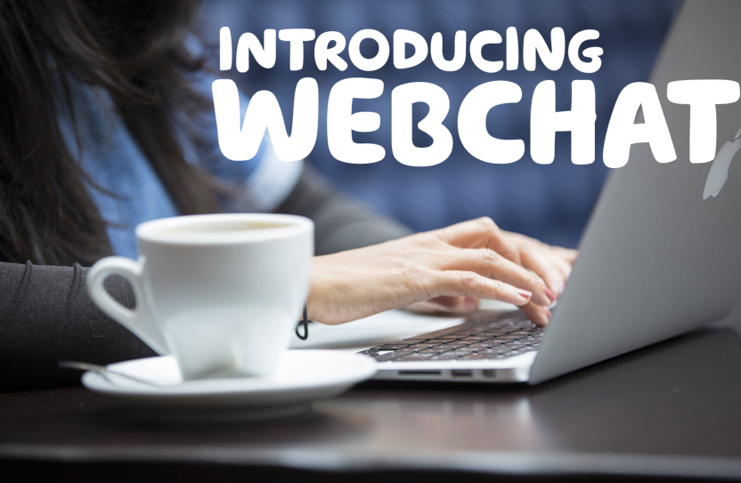 The words 'Introducing webchat' written over an image of someone typing on a laptop next to a cup of tea..