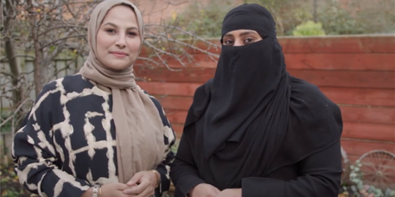 two people wearing hijab and headscarf looking at the camera