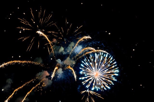 An image of bright fireworks across a dark black sky