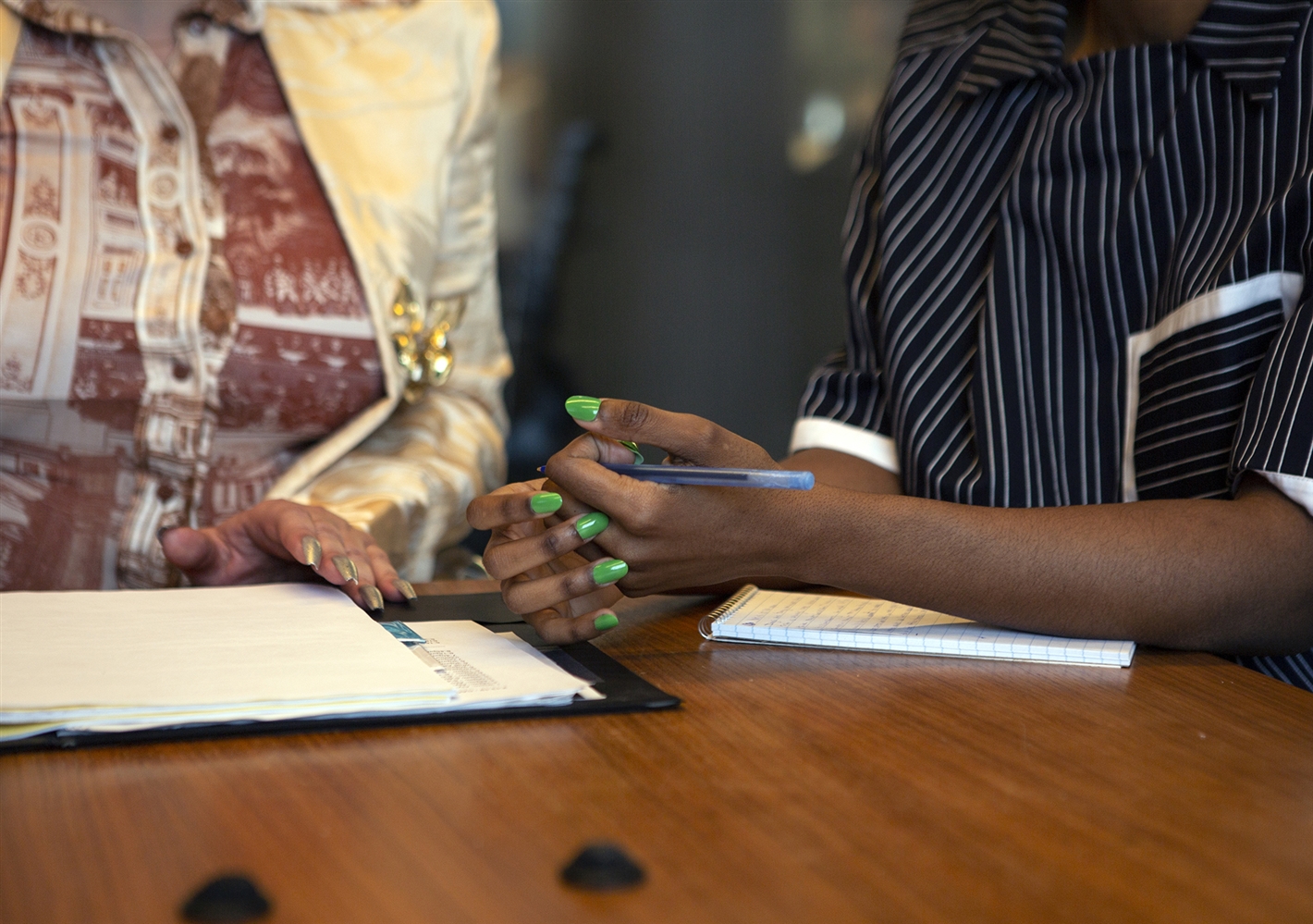 An image of two colleagues in a meeting at work