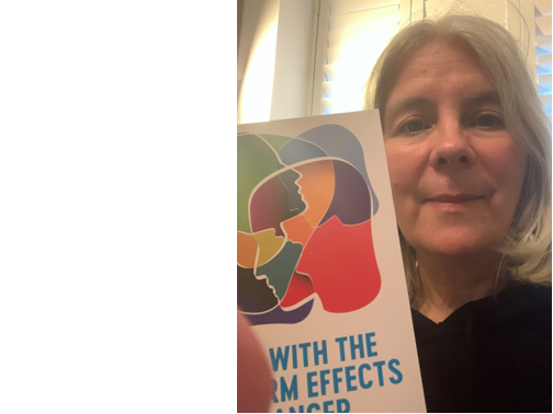  Community member ‘Cordelia’ holding a cancer effects pamphlet. 