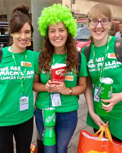 This photo shows Lucy, Hannah and Elissia. Hannah is wearing a wig and holding a box of celebrations. 