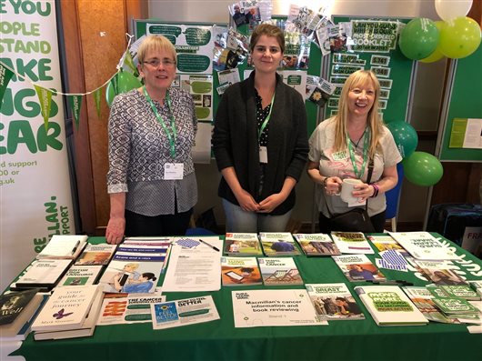 This image shows Macmillan staff Sue and Helen and volunteer reviewer Irene, at the Cancer Information Development stand at this year's Volunteer Conference.