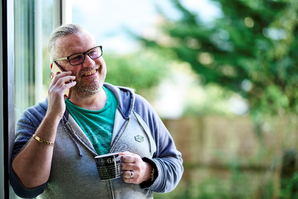 Person on the phone sat in front of the window