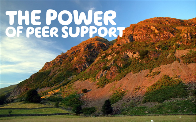 The power of peer support, written in white letters over a photograph of the sun shining two large hills.