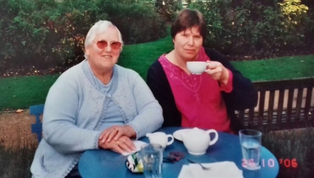 Holly and her mum sat having tea in the garden.
