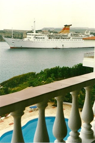 Photograph from Willo's holiday balcony of a large ship in a harbour in Menorca.