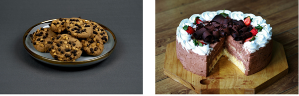 Cookies on a silver plate and a cake on aa wooden tray