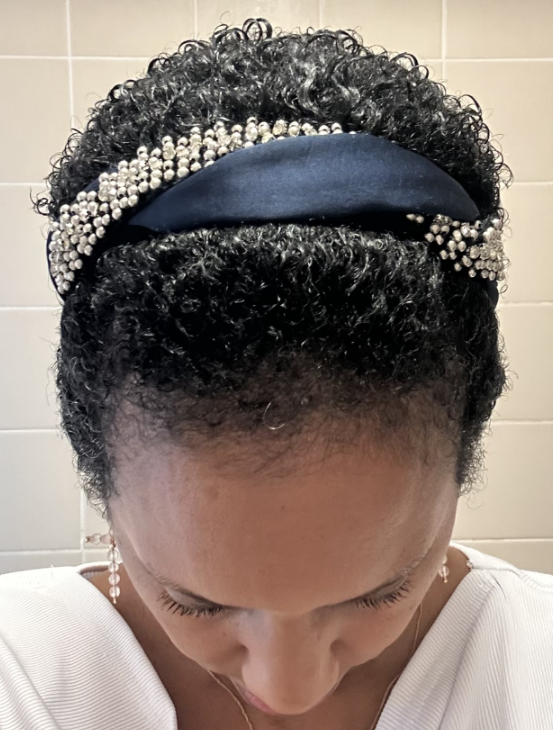 A photo of Wanda with short dark afro hair growing back after chemo