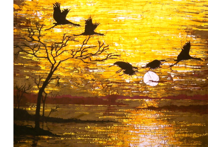  The shadow of a tree twigs and birds in the orange sunset and water below