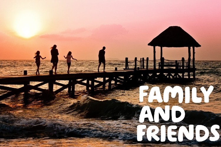  "Family and friends" written over a picture of a silhouette of a family walking along a pier at sunset