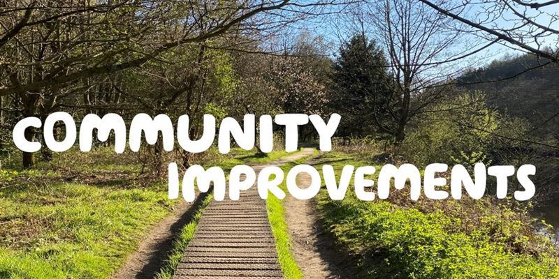 Image of a path with 'Community Improvements' in writing 