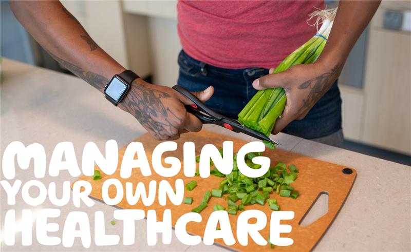 Close-up of a disabled and Black non-binary person with tattoos cutting green onions with kitchen scissors.
