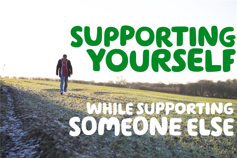 "Supporting someone while supporting someone else" written over a picture of a man walking by himself in a wheat field, with a white sky background.