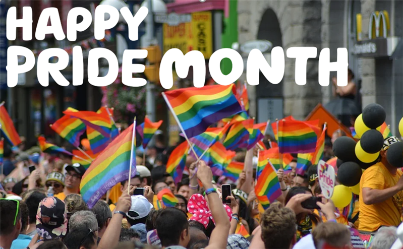 "Happy pride month" written over the image of a Pride march, with many individuals waving small Pride flags.