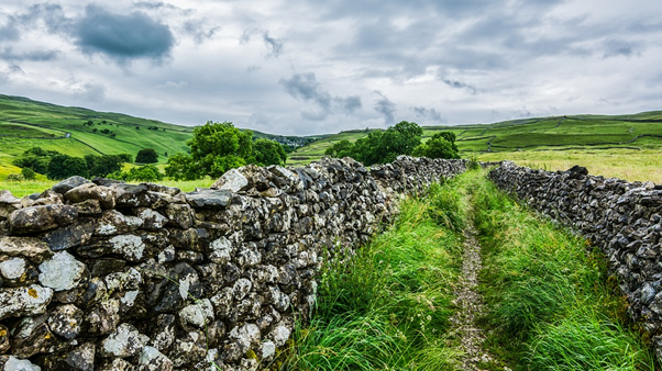 Stone walls surrounded by green fields