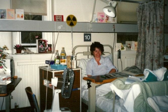  Photograph of Willo, sat up and smiling in a hospital bed